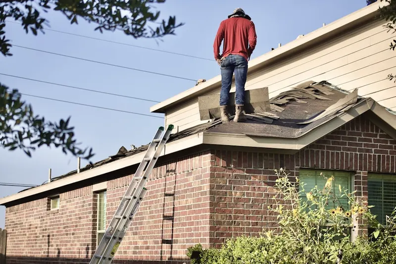 Professional roofer working on a residential roof in North Canton